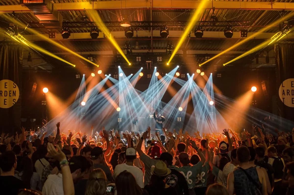 A concert crowd under bright stage lights