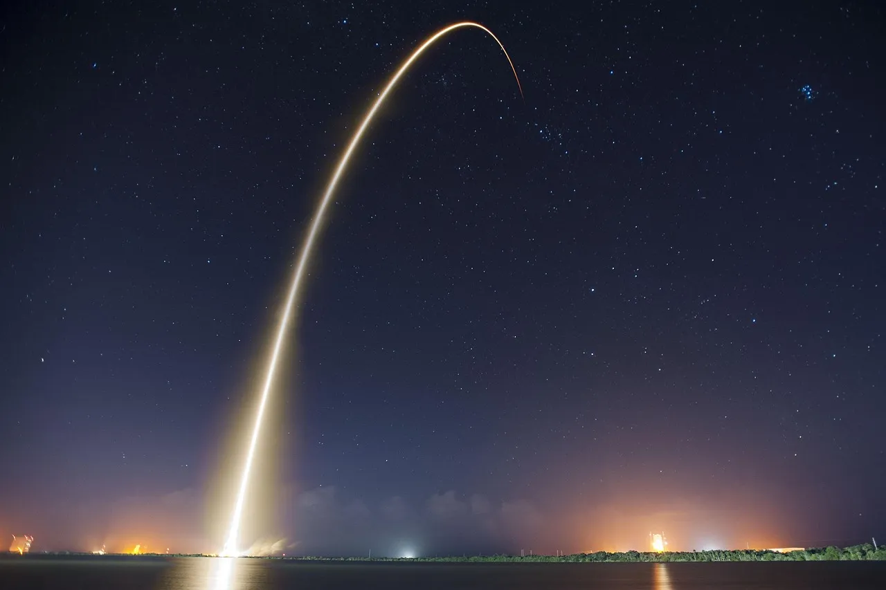 A rocket launch trail arcing across the night sky