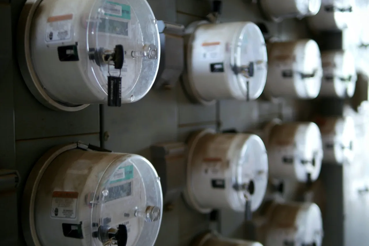 Rows of electric meters mounted on a wall