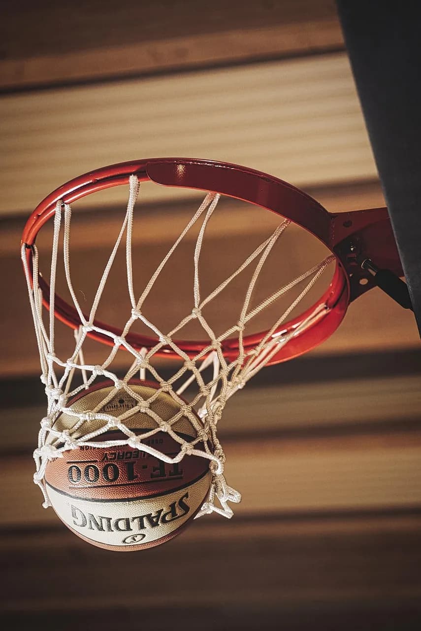 A basketball dropping through the net
