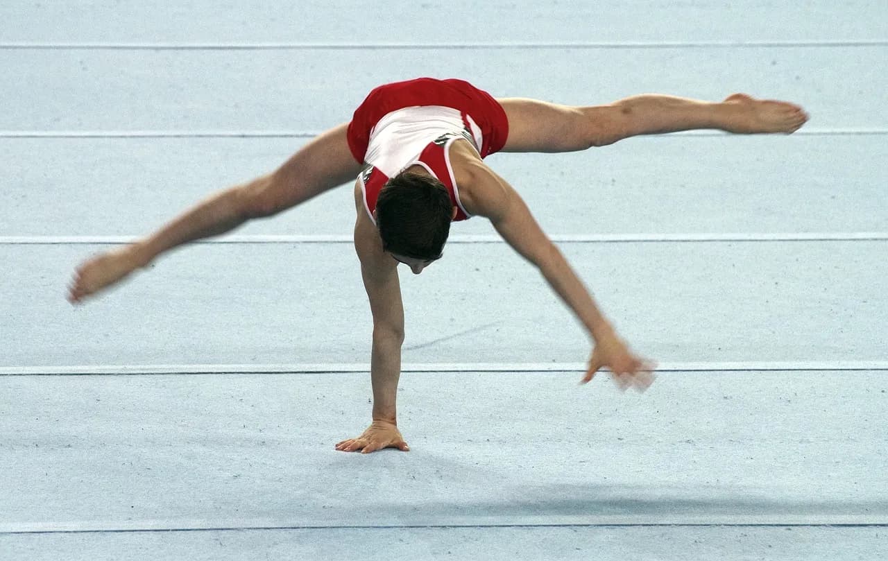A male gymnast performing a floor exercise routine